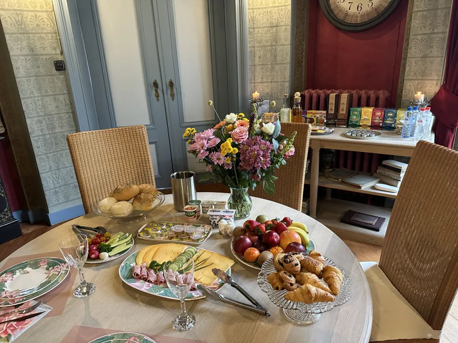 Generous breakfast with fresh bread, fruit, cheese and coffee