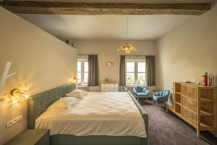 Comfortable Standard Room with wooden beam and blue armchairs